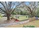 Green house exterior with driveway and landscaping at 11730 Sw 230Th Avenue Rd, Dunnellon, FL 34431