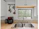 Close-up of a kitchen sink with a view to the exterior and a 'Coffee Bar' sign at 11730 Sw 230Th Avenue Rd, Dunnellon, FL 34431