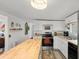 Modern kitchen with white cabinets and butcher block countertops at 11730 Sw 230Th Avenue Rd, Dunnellon, FL 34431