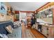 Cozy living room featuring hardwood floors and a large TV at 11730 Sw 230Th Avenue Rd, Dunnellon, FL 34431