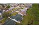 Aerial view of a house with a green roof and screened porch at 1309 Ballesteros Dr, The Villages, FL 32162