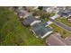 Aerial view of a house with a green roof and screened patio at 1309 Ballesteros Dr, The Villages, FL 32162