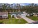 Aerial view of a single-Gathering home with a green roof and driveway at 1309 Ballesteros Dr, The Villages, FL 32162