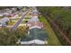 Aerial view of a house with a green roof and backyard at 1309 Ballesteros Dr, The Villages, FL 32162