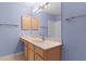 Bathroom with double vanity and large mirror at 1309 Ballesteros Dr, The Villages, FL 32162