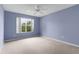 Spacious bedroom with light purple walls and ceiling fan at 1309 Ballesteros Dr, The Villages, FL 32162