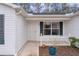 Front door entry with white picket fence and landscaping at 1309 Ballesteros Dr, The Villages, FL 32162