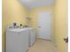 Laundry room with washer, dryer, and shelving at 1309 Ballesteros Dr, The Villages, FL 32162