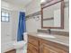 Clean bathroom, wood vanity, and updated fixtures at 2160 Boardman Rd, Bartow, FL 33830