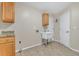 Laundry room with utility sink, cabinets, and tile floor at 2160 Boardman Rd, Bartow, FL 33830