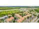 Aerial view of large apartment community with tennis court and pond at 3036 Parkway Blvd # 206, Kissimmee, FL 34747