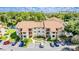 Aerial view of a two-story condo building with ample parking at 3036 Parkway Blvd # 206, Kissimmee, FL 34747