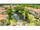 Aerial view of community with pond, deck, and lush landscaping at 3036 Parkway Blvd # 206, Kissimmee, FL 34747