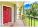 Condo balcony with red door and view of pond at 3036 Parkway Blvd # 206, Kissimmee, FL 34747