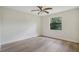 Bright bedroom with large window and wood-look floors at 3036 Parkway Blvd # 206, Kissimmee, FL 34747