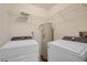 Bright laundry room, washer, dryer, and shelving at 3036 Parkway Blvd # 206, Kissimmee, FL 34747