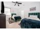 Bright bedroom with two twin beds, ceiling fan, and wood-look floors at 379 Villa Sorrento # Lot 40, Haines City, FL 33844