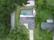 Aerial view showing house, pool, and solar panels at 5615 Driftwood Dr, Lakeland, FL 33809