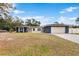 Newly renovated home exterior with a two-car garage at 5615 Driftwood Dr, Lakeland, FL 33809