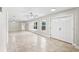 Bright and airy living room with tile floors and double doors at 5615 Driftwood Dr, Lakeland, FL 33809