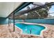 Inviting kidney-shaped pool with screened enclosure at 5615 Driftwood Dr, Lakeland, FL 33809