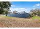 Screened pool area with a privacy wall and spacious yard at 5615 Driftwood Dr, Lakeland, FL 33809