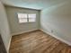 Bright bedroom with wood-look floors and large window at 605 Aldama Ct, Ocoee, FL 34761