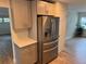 Stainless steel refrigerator in updated kitchen with light gray cabinets at 605 Aldama Ct, Ocoee, FL 34761