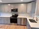 Modern kitchen featuring stainless steel appliances and white quartz countertops at 605 Aldama Ct, Ocoee, FL 34761