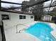 Inviting pool with a safety rail and screened enclosure at 605 Aldama Ct, Ocoee, FL 34761