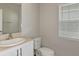 Simple bathroom with white vanity, toilet and window at 2204 Canyon Oak Dr, Davenport, FL 33837