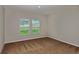 Spacious bedroom with neutral carpeting and two large windows at 2204 Canyon Oak Dr, Davenport, FL 33837