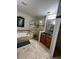 Well-lit bathroom featuring a soaking tub, glass shower, and vanity with granite countertops at 113 Walton Heath Dr, Orlando, FL 32828