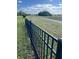 Modern black metal fence outlines a grassy area, providing security and a clear boundary to the property at 113 Walton Heath Dr, Orlando, FL 32828