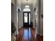 Elegant foyer with gleaming hardwood floors and arched doorway, showcasing a welcoming entrance at 113 Walton Heath Dr, Orlando, FL 32828