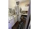 Well-equipped laundry room featuring a stacked washer and dryer, ample counter space, and built-in cabinetry at 113 Walton Heath Dr, Orlando, FL 32828