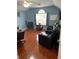 Comfortable living room with hardwood floors, lots of natural light, and nice furniture at 113 Walton Heath Dr, Orlando, FL 32828