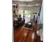 Open-concept living room featuring gleaming hardwood floors and seamless flow to the kitchen at 113 Walton Heath Dr, Orlando, FL 32828