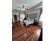 Spacious main bedroom with ceiling fan, wood floors, and sliding door access to the lanai at 113 Walton Heath Dr, Orlando, FL 32828