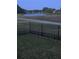 View of a community pond from the fenced-in yard with an adjacent walking trail at 113 Walton Heath Dr, Orlando, FL 32828