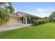 The backyard has a screened lanai and manicured landscaping at 27100 Racquet Cir, Leesburg, FL 34748