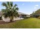 Spacious backyard with lush lawn and screened enclosure at 27100 Racquet Cir, Leesburg, FL 34748