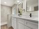 Beautiful bathroom features a double sink vanity with quartz countertop and a walk-in shower with tiled surround at 27100 Racquet Cir, Leesburg, FL 34748
