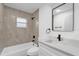 Updated bathroom with modern vanity, fixtures, and shower/tub combo at 27100 Racquet Cir, Leesburg, FL 34748