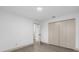 Bedroom with access to another room and wood-look floors at 27100 Racquet Cir, Leesburg, FL 34748