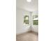 Bright corner bedroom with windows overlooking lush landscaping and greenery at 27100 Racquet Cir, Leesburg, FL 34748