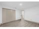 Bright bedroom featuring wood-look floors and ample closet space at 27100 Racquet Cir, Leesburg, FL 34748