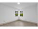 Bright bedroom with two windows and wood-look floors at 27100 Racquet Cir, Leesburg, FL 34748