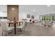 Bright dining area with modern table and chairs, adjacent to living room at 27100 Racquet Cir, Leesburg, FL 34748