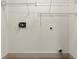 Empty laundry room has wire racks for storage at 27100 Racquet Cir, Leesburg, FL 34748